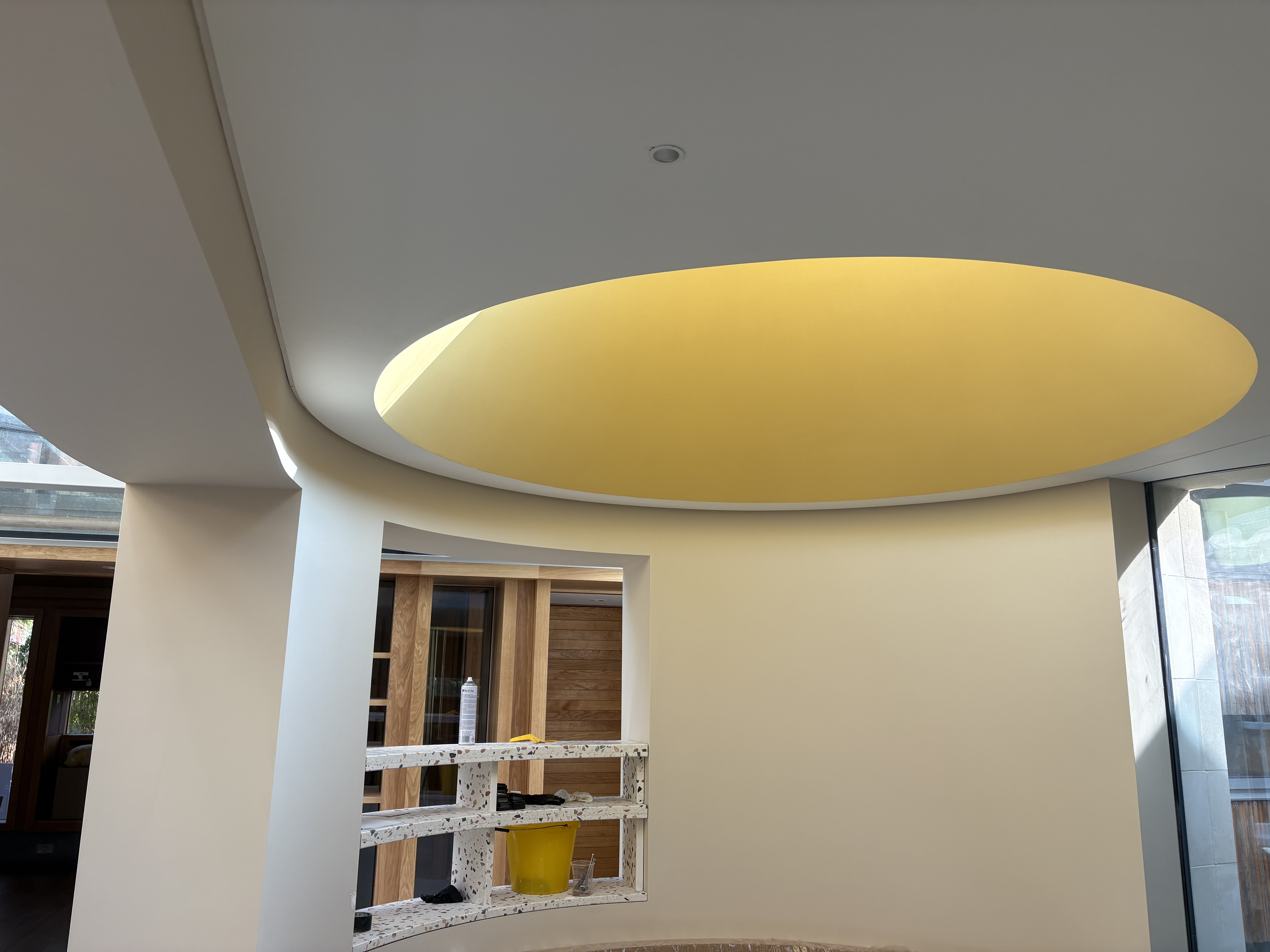 Modern interior with curved walls and illuminated oval ceiling feature